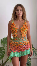 Front view of model wearing Lime Green 3D crochet cutout mini dress with orange and pink accents