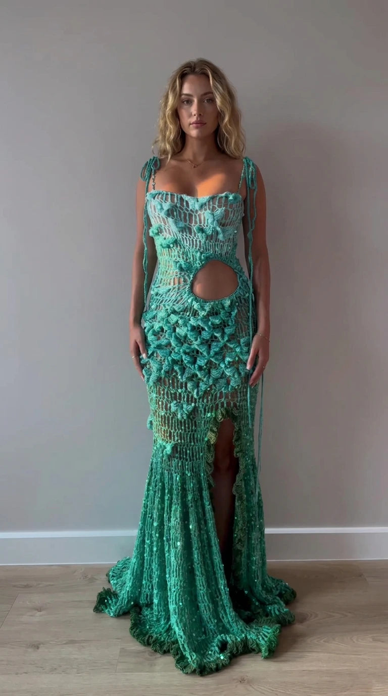 Front full view of woman wearing teal green sequined crochet cut-out maxi gown with 3D floral details
