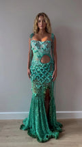 Front full view of woman wearing teal green sequined crochet cut-out maxi gown with 3D floral details