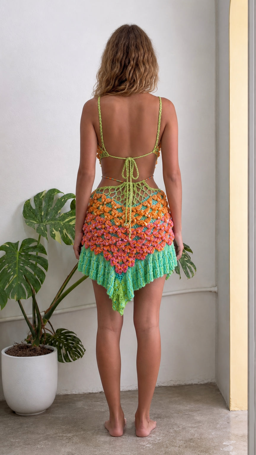 Back view of model wearing Lime Green open back crochet mini dress with tie closures
