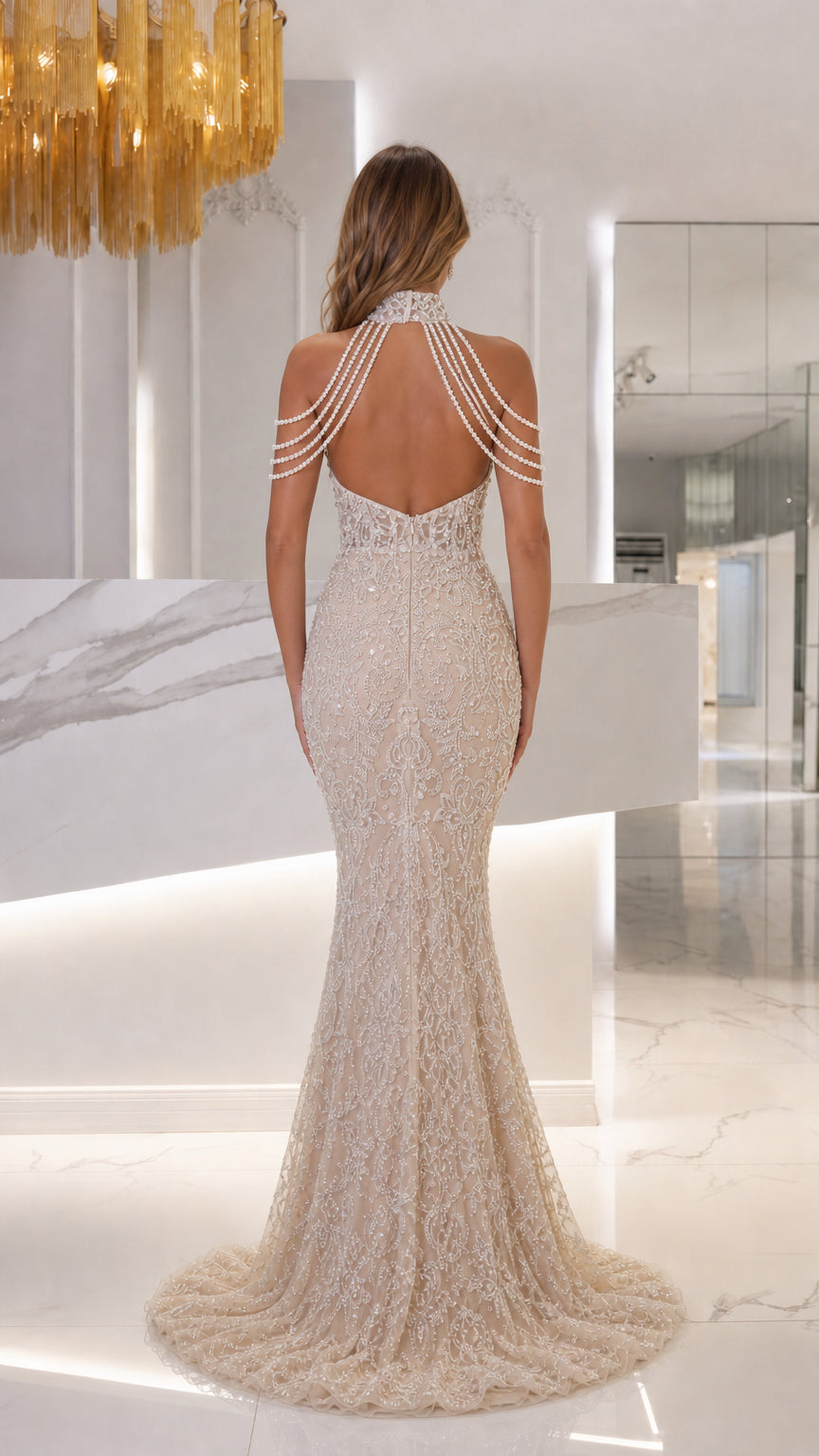 Back view of champagne open back mermaid evening gown with pearl shoulder draping