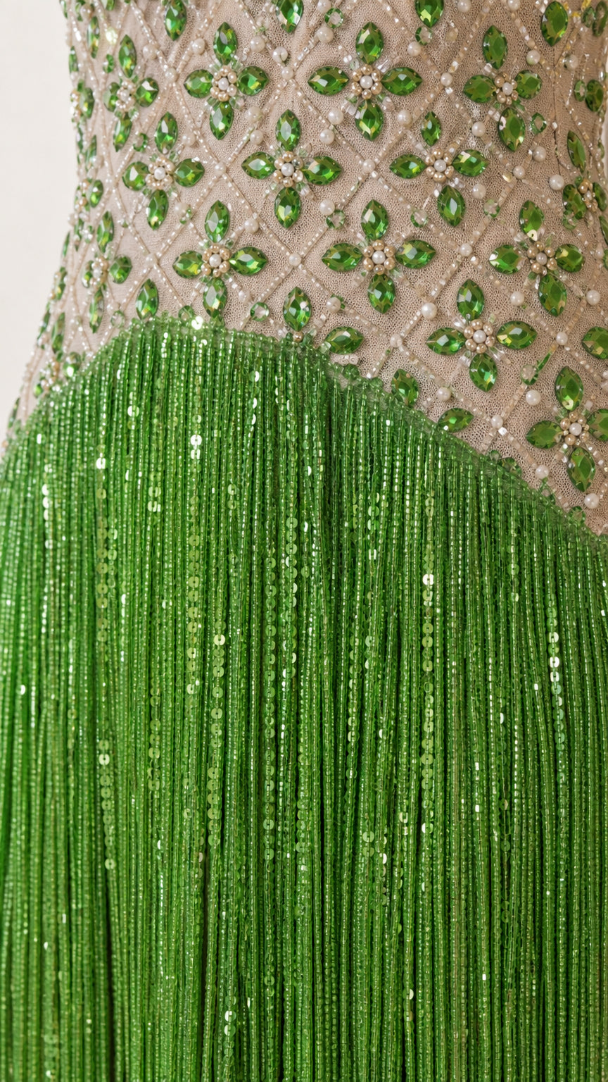Close-up detail of green rhinestone lattice bodice and sequined fringe skirt