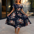 Florenza – Floral Pleated Midi Dress with Tie Waist and Flutter Sleeves